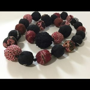Fabric covered bead necklace.